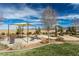 Community playground with seating area, picnic benches, shade structure, and lush greenery at 5265 Lucca Ln, Pahrump, NV 89061