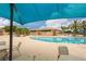 Stunning pool with blue umbrellas, lounge chairs, and views of the community at 5265 Lucca Ln, Pahrump, NV 89061