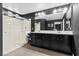 Modern bathroom with sleek black cabinets, double sinks, and glass shower at 5419 Holding Ave, Las Vegas, NV 89139