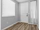 Cozy entryway featuring a white door, window with blinds, and wood-look floors at 5419 Holding Ave, Las Vegas, NV 89139