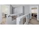 Upstairs hallway with glass railing, featuring access to bathroom and bedroom at 5419 Holding Ave, Las Vegas, NV 89139