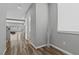 Hallway with wood flooring leading to a living room with lots of natural light at 5419 Holding Ave, Las Vegas, NV 89139