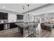 Open kitchen with a large center island, barstool seating and view into dining and living area at 5419 Holding Ave, Las Vegas, NV 89139