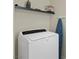 Laundry room with modern, front-load washing machine and shelf at 5419 Holding Ave, Las Vegas, NV 89139