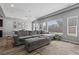 Spacious living area with a comfortable sectional couch, decorative lighting, and large windows offering natural light at 5419 Holding Ave, Las Vegas, NV 89139