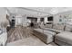 Open-concept living area with a large sectional, a modern kitchen, and plenty of natural light, perfect for entertaining at 5419 Holding Ave, Las Vegas, NV 89139