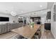 Open-concept living room with modern lighting, kitchen bar, and contemporary furniture at 5419 Holding Ave, Las Vegas, NV 89139