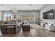 Open living room with a large sectional couch, natural light, and contemporary décor, creating a comfortable atmosphere at 5419 Holding Ave, Las Vegas, NV 89139