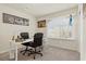 Bright office space with two desks, comfortable chairs, a large window and carpet flooring for a work environment at 5419 Holding Ave, Las Vegas, NV 89139