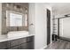 Modern bathroom featuring a stylish vanity, vessel sink, and sleek, tiled shower with black trim at 5612 Coder Ct, Las Vegas, NV 89118