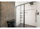 Updated bathroom with black fixtures, tiled shower, and decorative accent wall at 5612 Coder Ct, Las Vegas, NV 89118