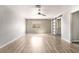Spacious bedroom with a ceiling fan, a window and an accented wall design, along with wood-look floors at 5612 Coder Ct, Las Vegas, NV 89118
