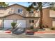 Charming townhome featuring attached garages, manicured landscaping, and a welcoming facade at 5612 Coder Ct, Las Vegas, NV 89118
