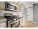Functional kitchen showcases stainless steel appliances and neutral-toned cabinetry and tile floors at 5612 Coder Ct, Las Vegas, NV 89118