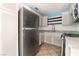 Kitchen featuring stainless steel refrigerator, white cabinets, neutral countertops and tile floors at 5612 Coder Ct, Las Vegas, NV 89118