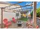 Backyard seating area with firepit and string lights, perfect for entertaining at 6331 Regina Ridge St, Las Vegas, NV 89149