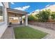 Relaxing outdoor space with turf, gravel, brick retaining wall, and covered patio at 6331 Regina Ridge St, Las Vegas, NV 89149