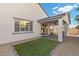 Outdoor space with lush turf, gravel surround, and a covered patio area at 6331 Regina Ridge St, Las Vegas, NV 89149