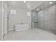 Bright bathroom featuring a soaking tub and glass shower, offering a spa-like experience at 6331 Regina Ridge St, Las Vegas, NV 89149