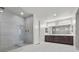 Bright bathroom with a glass-enclosed shower, double vanity with sinks, and tile flooring at 6331 Regina Ridge St, Las Vegas, NV 89149