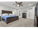 Comfortable bedroom with a dark wood bed frame, plush carpeting, and ample natural light at 6331 Regina Ridge St, Las Vegas, NV 89149