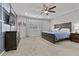 Primary bedroom featuring a statement wall, carpeted floors, and a ceiling fan at 6331 Regina Ridge St, Las Vegas, NV 89149