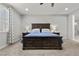 Relaxing bedroom featuring a dark wood bed frame, plush carpeting, and dual nightstands with lamps at 6331 Regina Ridge St, Las Vegas, NV 89149