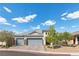 Beautiful single-story home with a three-car garage, desert landscaping, and gray accents at 6331 Regina Ridge St, Las Vegas, NV 89149