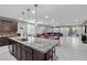 Open concept kitchen with island, granite countertops, stainless steel appliances, and backyard access at 6331 Regina Ridge St, Las Vegas, NV 89149