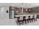 Open-concept kitchen featuring a center island, stainless steel appliances, custom cabinetry, and pendant lighting at 6331 Regina Ridge St, Las Vegas, NV 89149