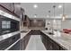 Beautiful kitchen with granite countertops, stainless steel appliances, and dark wood cabinets at 6331 Regina Ridge St, Las Vegas, NV 89149