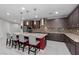 Large kitchen featuring an island with bar seating, pendant lighting, stainless steel appliances, and tile floors at 6331 Regina Ridge St, Las Vegas, NV 89149