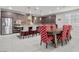 Well-lit kitchen and dining area with stainless steel appliances, granite countertops, and a wooden dining table at 6331 Regina Ridge St, Las Vegas, NV 89149