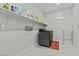 Well-lit laundry room features a modern washer/dryer set, open shelving, and ample storage space at 6331 Regina Ridge St, Las Vegas, NV 89149
