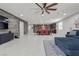 Open concept living room featuring tile flooring, an eat-in kitchen, with views into other areas of the home at 6331 Regina Ridge St, Las Vegas, NV 89149