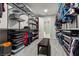 Well-organized walk-in closet with ample storage and a convenient central bench at 6331 Regina Ridge St, Las Vegas, NV 89149