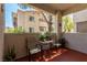 Outdoor balcony with chairs and lush greenery with a view of the surrounding buildings at 6480 Annie Oakley Dr # 814, Las Vegas, NV 89120