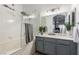 Updated bathroom featuring a shower-over-tub with glass door and modern vanity at 6480 Annie Oakley Dr # 814, Las Vegas, NV 89120