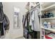 Walk-in closet with ample shelving, hanging space, and mirrored accent at 6480 Annie Oakley Dr # 814, Las Vegas, NV 89120