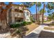 Charming condo exterior with well-maintained landscaping, inviting walkways, and beige stucco at 6480 Annie Oakley Dr # 814, Las Vegas, NV 89120