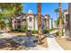 Exterior condo view features a walkway and cozy outdoor grill surrounded by lush trees at 6480 Annie Oakley Dr # 814, Las Vegas, NV 89120
