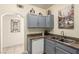 Compact kitchen with gray cabinetry, granite countertops, and stainless steel sink at 6480 Annie Oakley Dr # 814, Las Vegas, NV 89120