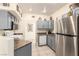Efficient kitchen featuring gray cabinets, stainless steel refrigerator, and granite countertops at 6480 Annie Oakley Dr # 814, Las Vegas, NV 89120