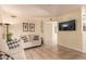 Bright living room with tile floors, cozy seating, and a mounted flat screen TV at 6480 Annie Oakley Dr # 814, Las Vegas, NV 89120