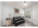 Comfortable sitting area with black leather sofa and natural light from the window at 6480 Annie Oakley Dr # 814, Las Vegas, NV 89120