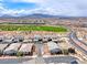 Expansive community aerial view showcases green spaces, modern homes, and stunning mountain views at 669 Assurance Pl, Henderson, NV 89011
