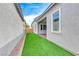 Artificial turf backyard with a patio and a modern exterior at 669 Assurance Pl, Henderson, NV 89011