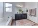 Elegant bathroom with a soaking tub, double vanity, and contemporary lighting at 669 Assurance Pl, Henderson, NV 89011