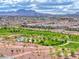 Scenic community park featuring lush greenery, walking paths, and mountain views at 669 Assurance Pl, Henderson, NV 89011