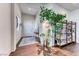 Bright foyer with wood-look floors, plants, and a view of the front door at 669 Assurance Pl, Henderson, NV 89011